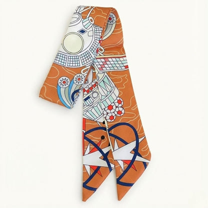 Foulard en satin orange avec motifs graphiques colorés, noué élégamment sur un fond neutre